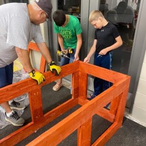 Adult teaching building skills to children